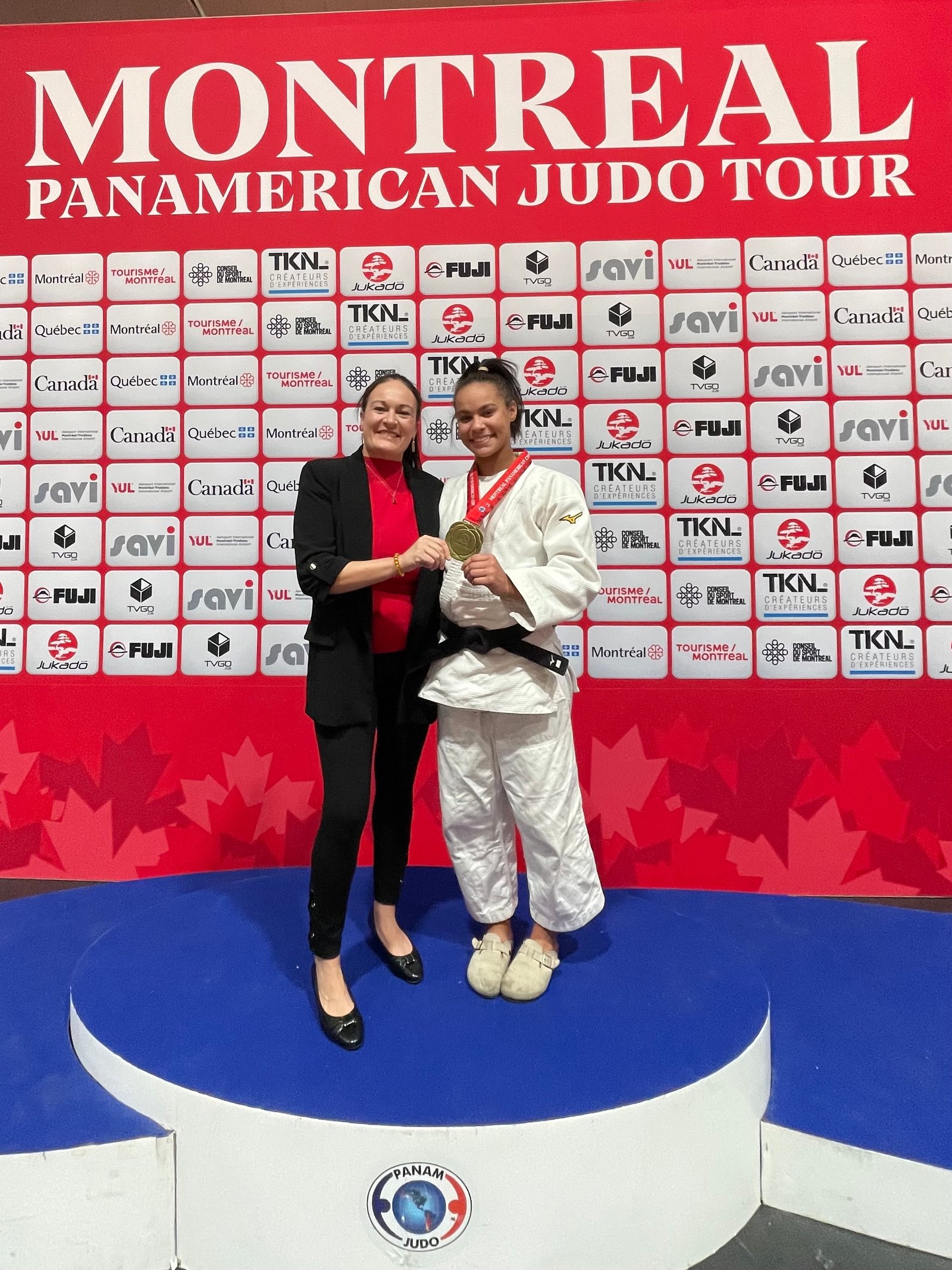 Carrie Chandler and Jayda at the Montreal Pan American Judo Tour, with Jayda holding her medal.